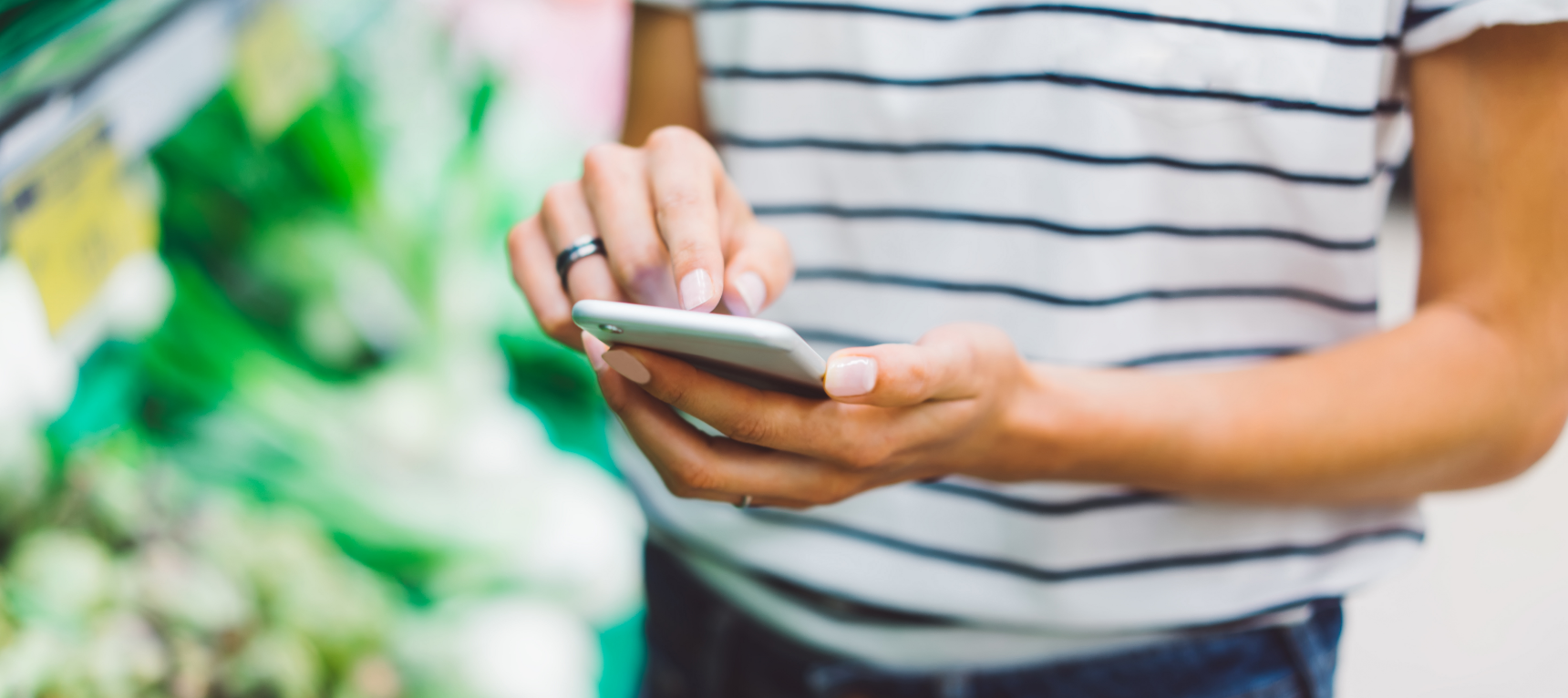 A grocery customer on their phone shopping online for groceries