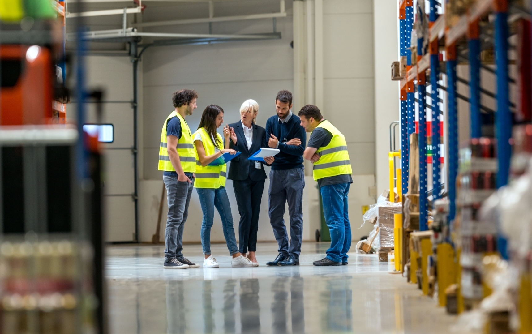 Group of Team Members Gathering in Distribution Warehouse