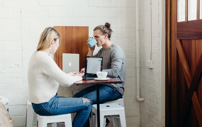 Two People Working and Enjoying a Cup of Coffee and Some Conversation