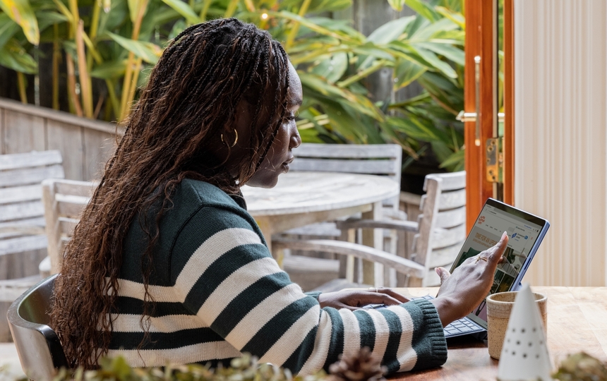 Woman in Coffee Shop Using a Tablet to Shop Online