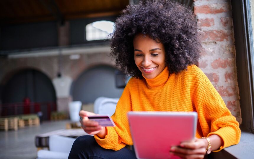 Woman Using Credit Card to Shop Online